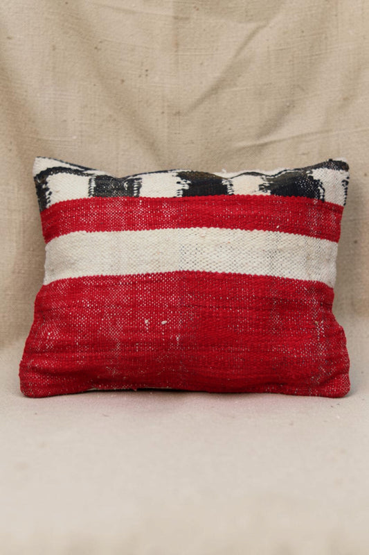 Reverse of the Moroccan cushion cover with broad red and cream bands and black detailing