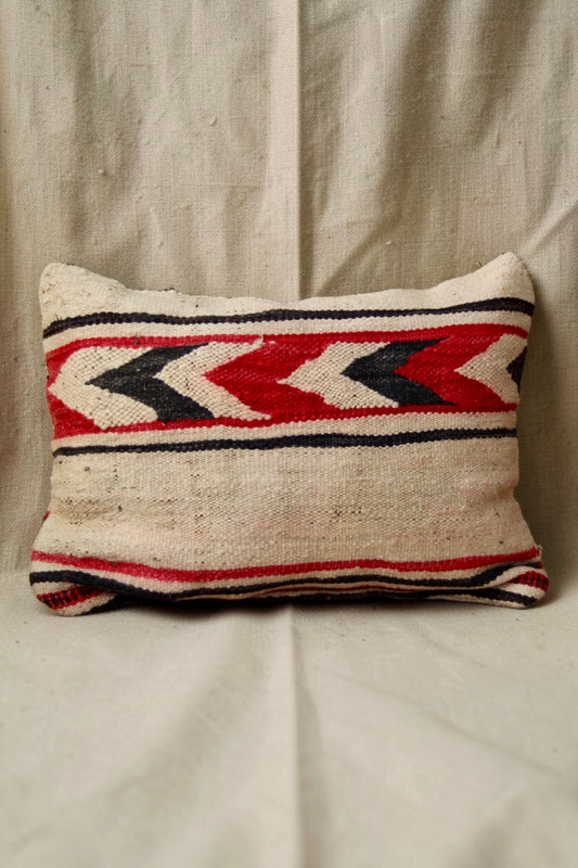 Cream Moroccan cushion cover showing a red, black and cream chevron-patterned band