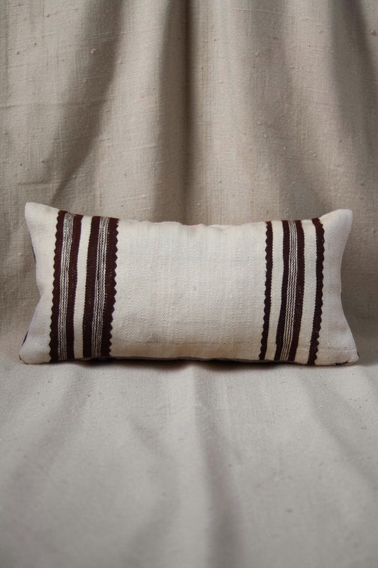 Cream Moroccan cushion cover with deep brown striped bands at each end, full view
