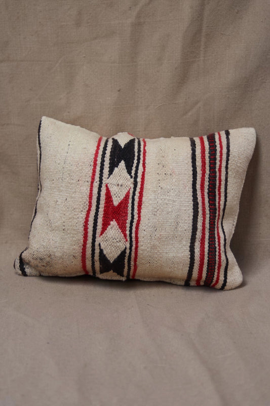 Cream Moroccan cushion cover with red and black geometric bands and stripes, full view
