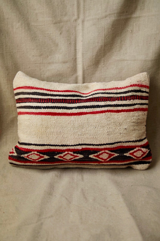 Cream Moroccan cushion cover with horizontal red and black stripes and a diamond-patterned band