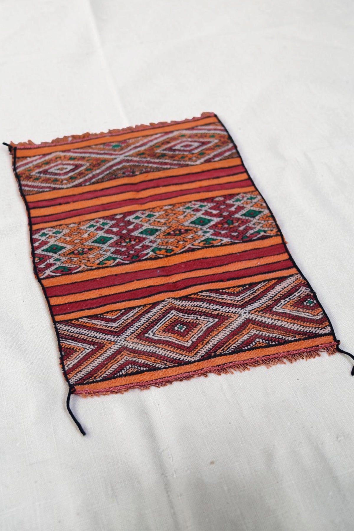 Full view of the striped and geometric bands on the vintage Moroccan flatweave