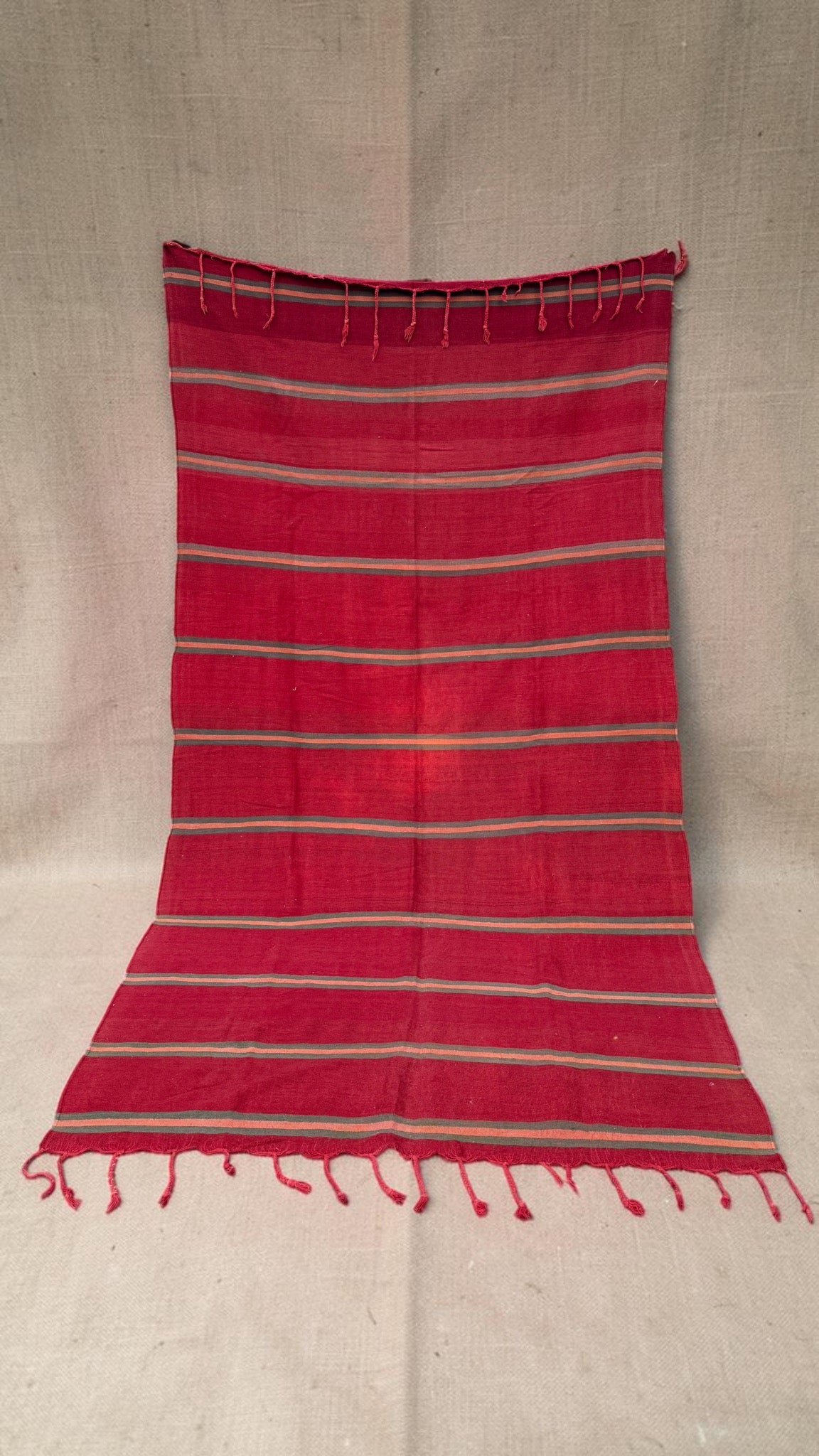 Vintage Moroccan red flatweave rug with narrow pink and grey-green stripes and tasselled ends