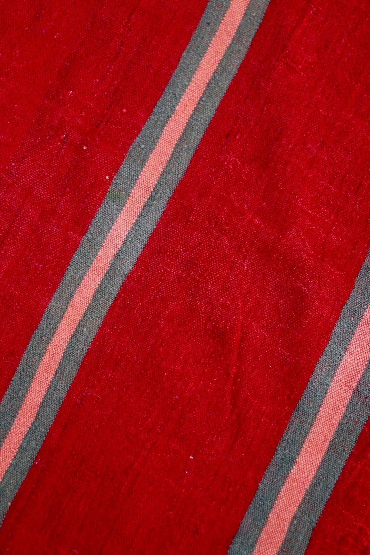 Close-up of the red weave and muted stripe detail