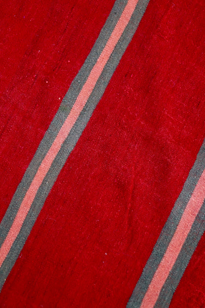Close-up of the red weave and muted stripe detail