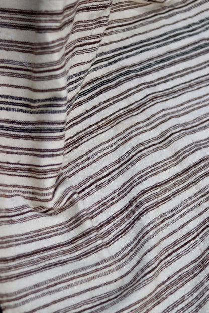 Draped view showing the fine weave of the cream and brown striped textile