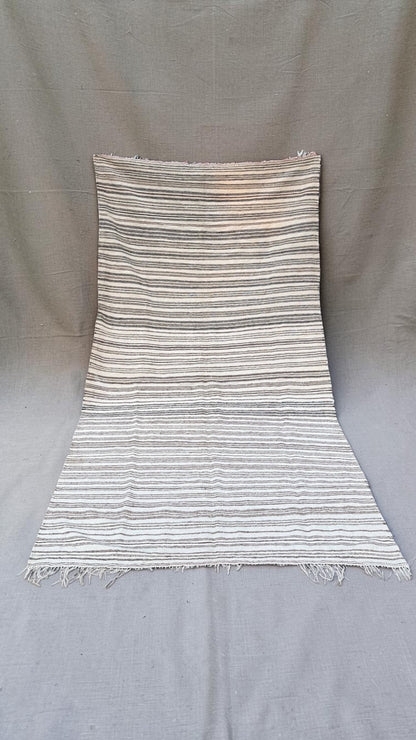 Vintage Moroccan flatweave throw with fine brown and charcoal stripes on a cream ground