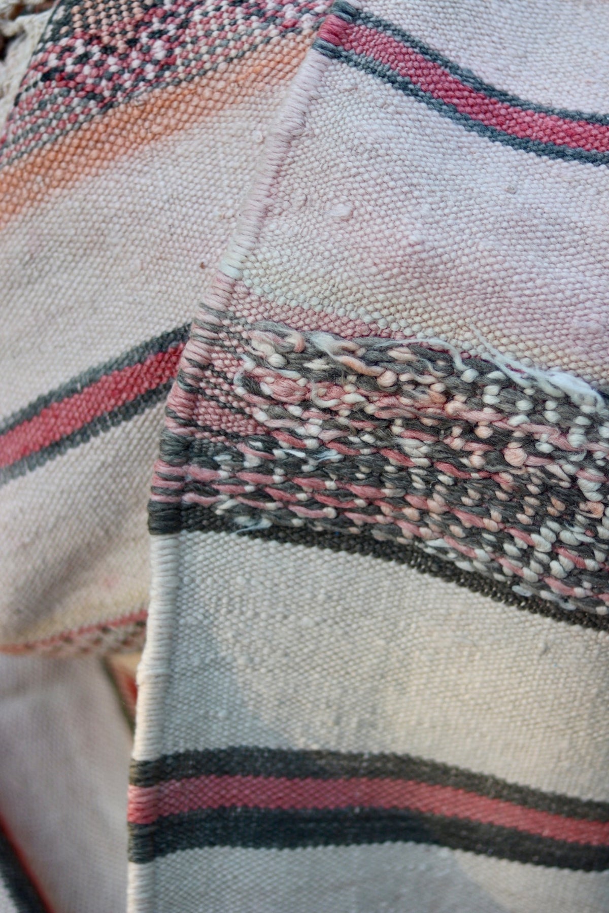 Reverse edge detail showing coloured yarns and the cream weave
