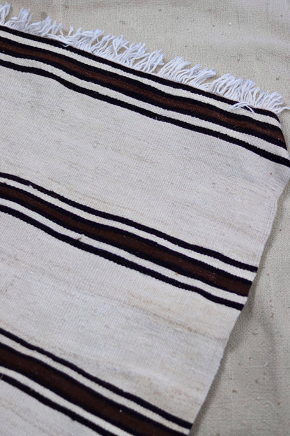 Pale fringed end and close-up of the striped flatweave